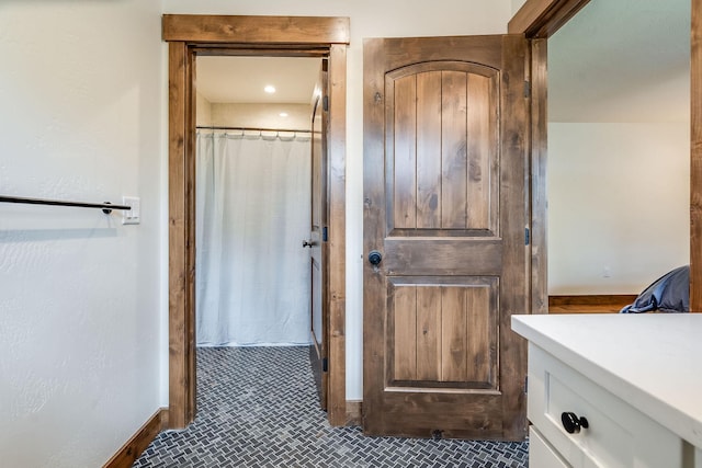 bathroom featuring vanity, tile patterned flooring, a shower with shower curtain, and baseboards