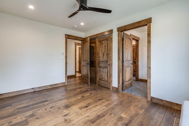 unfurnished bedroom with baseboards, wood finished floors, recessed lighting, a closet, and ceiling fan