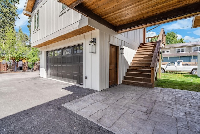 garage featuring asphalt driveway