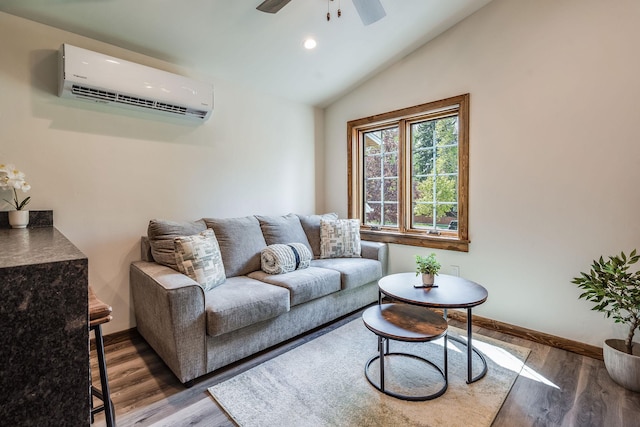 living room featuring a wall unit AC, ceiling fan, wood finished floors, baseboards, and recessed lighting
