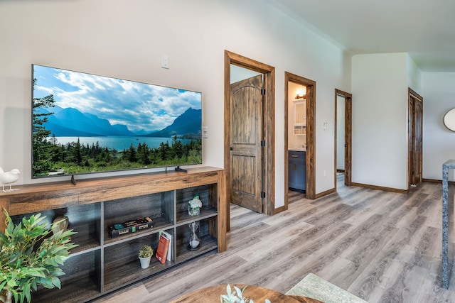 living area with wood finished floors and baseboards