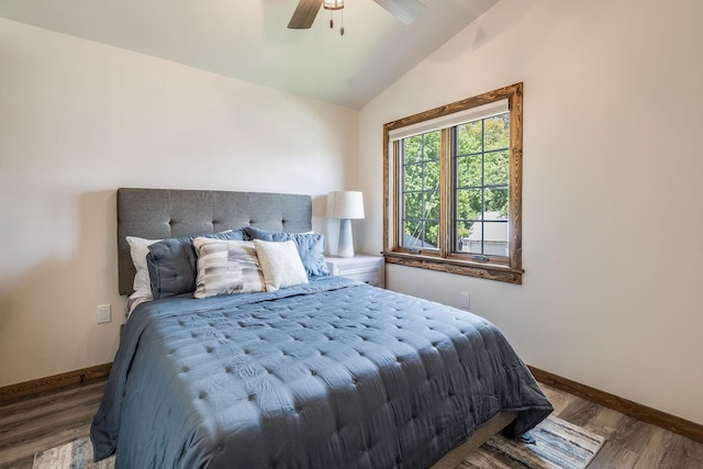 bedroom with vaulted ceiling, baseboards, wood finished floors, and ceiling fan