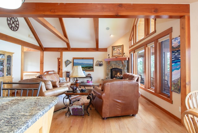 34520 Rocky Point Rd, Polson, MT 59860 - living room featuring a fireplace, beamed ceiling, light wood-type flooring, baseboards, and high vaulted ceiling