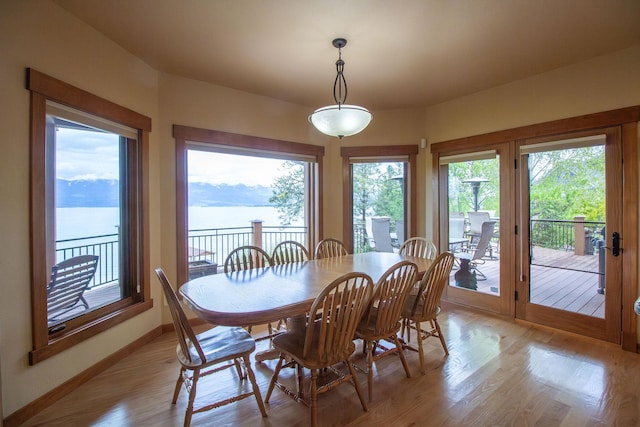 34520 Rocky Point Rd, Polson, MT 59860 - dining space featuring baseboards, light wood-style floors, and a water view