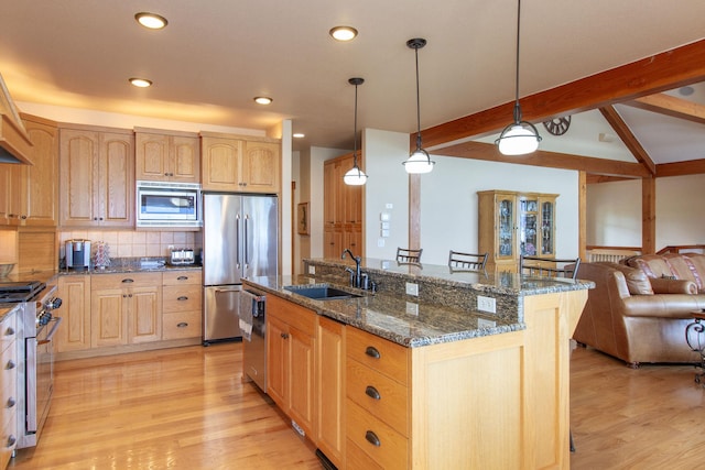 34520 Rocky Point Rd, Polson, MT 59860 - kitchen with high end appliances, open floor plan, light wood-style flooring, light brown cabinetry, and recessed lighting