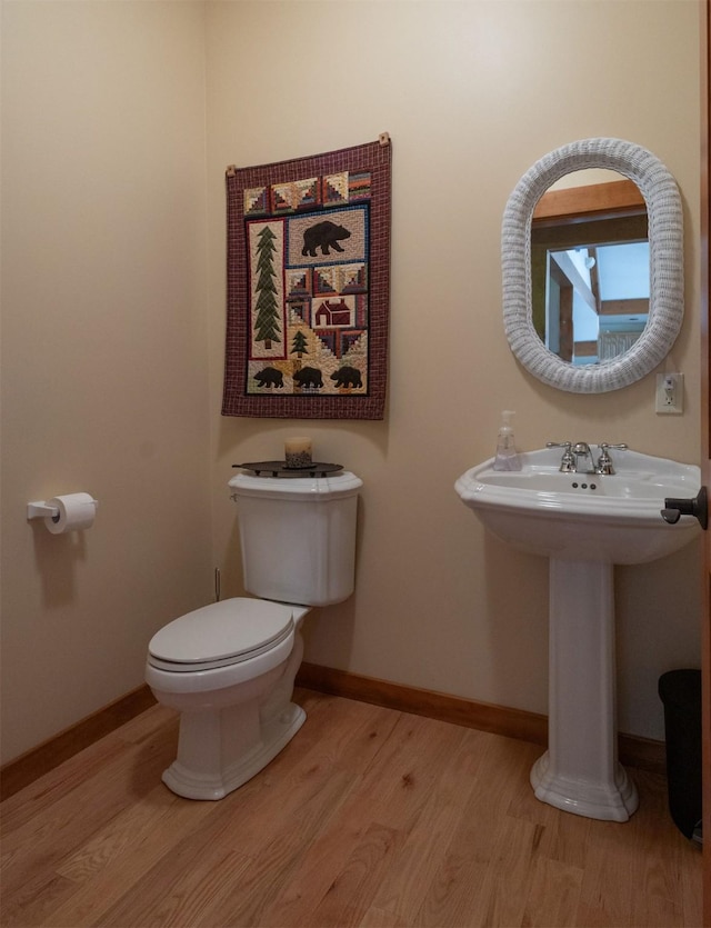 34520 Rocky Point Rd, Polson, MT 59860 - half bath with wood finished floors, toilet, baseboards, and a sink