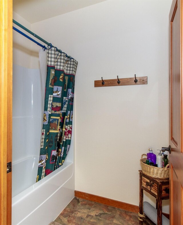 34520 Rocky Point Rd, Polson, MT 59860 - bathroom featuring baseboards and shower / tub combo
