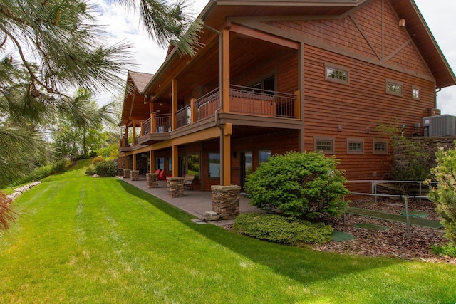 34520 Rocky Point Rd, Polson, MT 59860 - back of house featuring a balcony, central air condition unit, a yard, and a patio