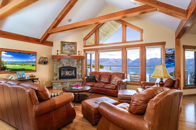 34520 Rocky Point Rd, Polson, MT 59860 - living room with high vaulted ceiling, beam ceiling, a water and mountain view, wood finished floors, and a stone fireplace