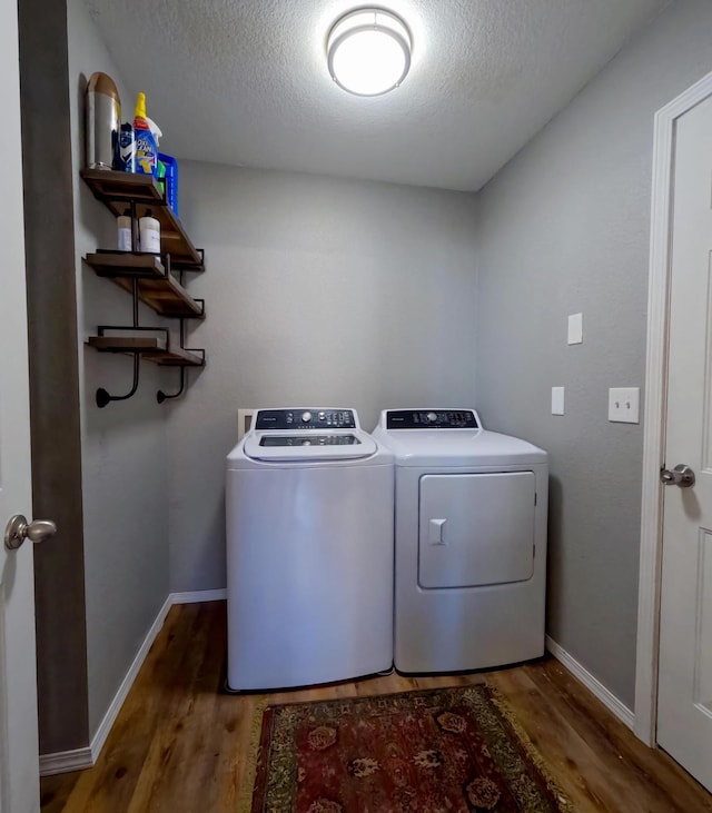 35881 Warbler Dr, Ronan, MT 59864 - laundry area with separate washer and dryer, wood finished floors, a textured ceiling, and baseboards