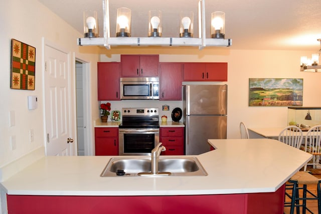 35881 Warbler Dr, Ronan, MT 59864 - kitchen with stainless steel appliances, a sink, a kitchen bar, and light countertops