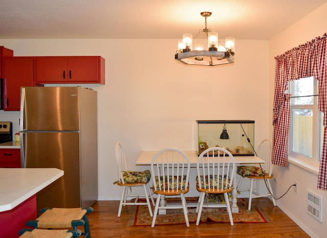 35881 Warbler Dr, Ronan, MT 59864 - dining room featuring a chandelier, wood finished floors, heating unit, and baseboards