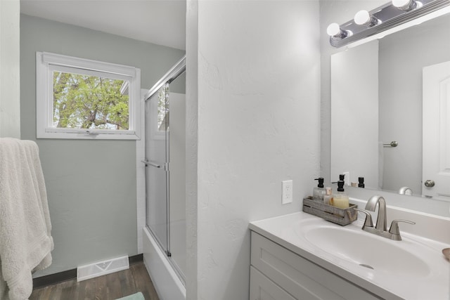 501 23rd Ave NE, Great Falls, MT 59404 - full bath with wood finished floors, vanity, enclosed tub / shower combo, and baseboards