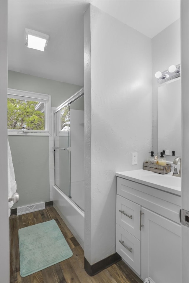 501 23rd Ave NE, Great Falls, MT 59404 - full bathroom featuring vanity, combined bath / shower with glass door, wood finished floors, and baseboards