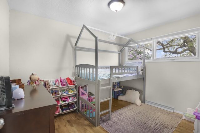 501 23rd Ave NE, Great Falls, MT 59404 - bedroom featuring baseboard heating and wood finished floors