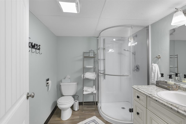 501 23rd Ave NE, Great Falls, MT 59404 - bathroom featuring wood finished floors, a shower stall, toilet, vanity, and baseboards