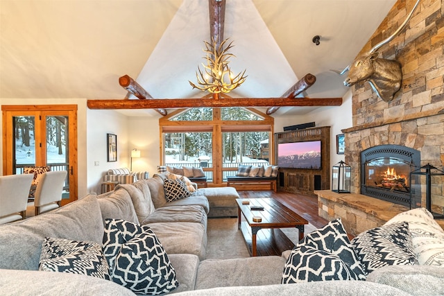 living room featuring french doors, hardwood / wood-style flooring, a fireplace, and high vaulted ceiling