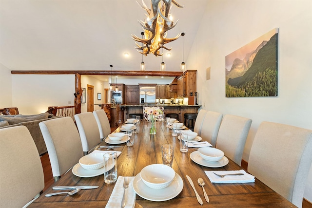 dining space with a chandelier, dark wood-type flooring, and a towering ceiling