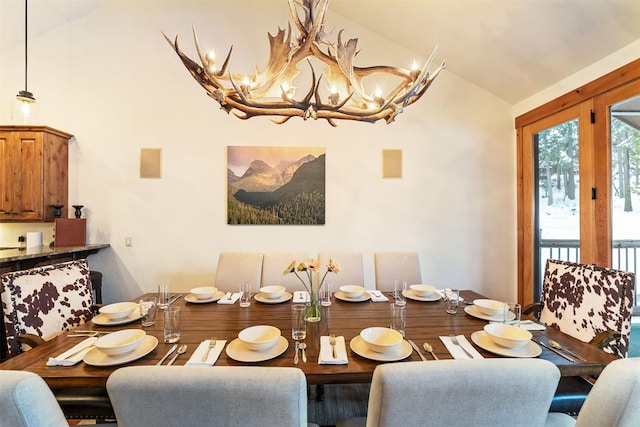 dining room featuring vaulted ceiling and a chandelier