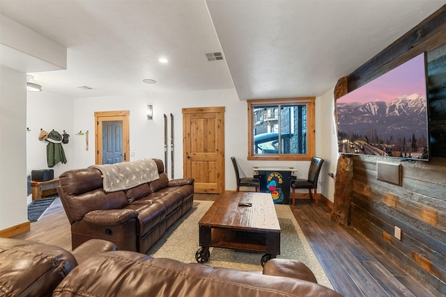 living area featuring wood finished floors, baseboards, and recessed lighting
