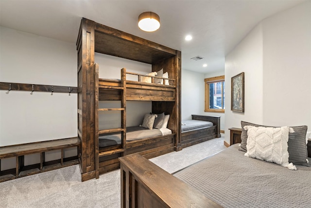 bedroom with light colored carpet and recessed lighting
