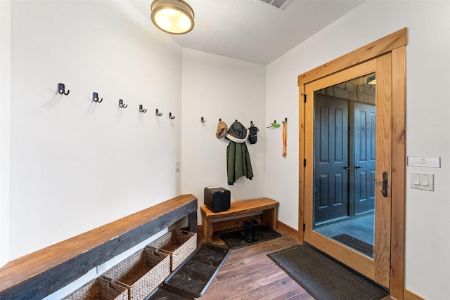 mudroom with wood finished floors and baseboards