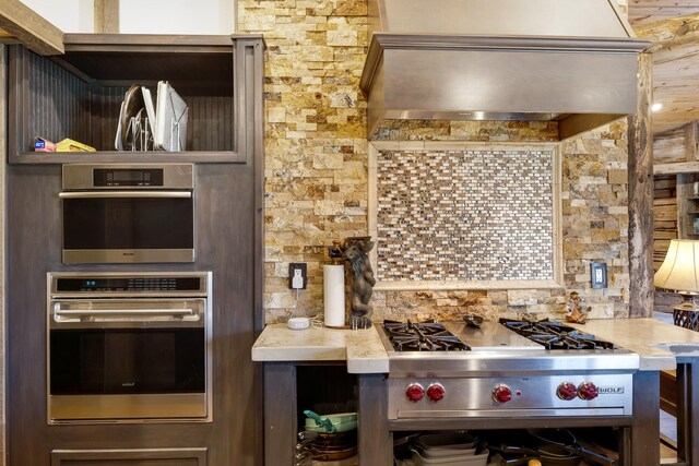 3690 Big Flat Rd, Missoula, MT 59804 - kitchen with appliances with stainless steel finishes, backsplash, and wall chimney range hood