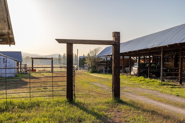 3690 Big Flat Rd, Missoula, MT 59804 - view of yard with an outdoor structure, fence, a mountain view, a pole building, and an exterior structure