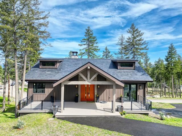 111 Blacktail Loop, Lakeside, MT 59922 - view of front of property featuring board and batten siding, covered porch, and a chimney