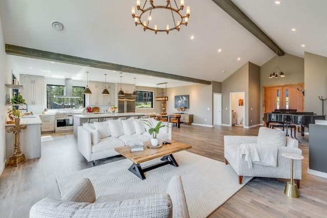 111 Blacktail Loop, Lakeside, MT 59922 - living room featuring a chandelier, beam ceiling, light wood-type flooring, high vaulted ceiling, and recessed lighting