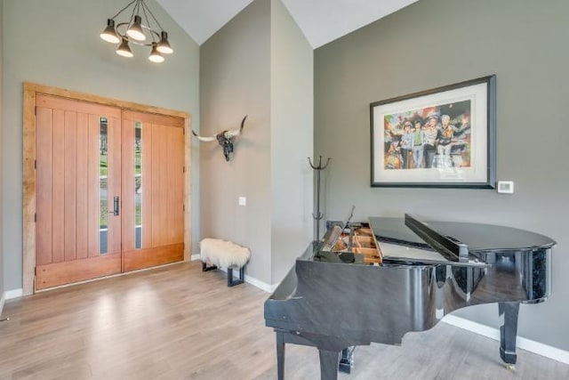 111 Blacktail Loop, Lakeside, MT 59922 - foyer entrance featuring high vaulted ceiling, wood finished floors, and a chandelier