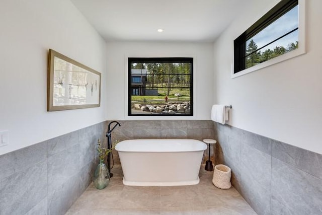 111 Blacktail Loop, Lakeside, MT 59922 - full bath featuring tile walls, a soaking tub, and wainscoting
