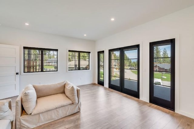111 Blacktail Loop, Lakeside, MT 59922 - living room featuring wood finished floors, plenty of natural light, french doors, and recessed lighting