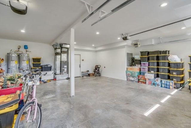 111 Blacktail Loop, Lakeside, MT 59922 - garage with water heater, recessed lighting, a garage door opener, and heating unit