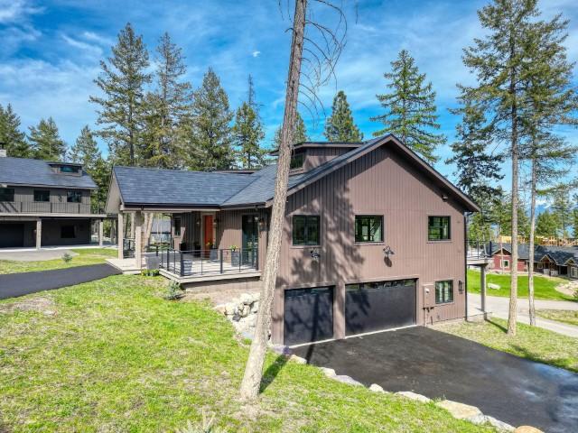 111 Blacktail Loop, Lakeside, MT 59922 - view of property exterior with a garage, driveway, a yard, and covered porch