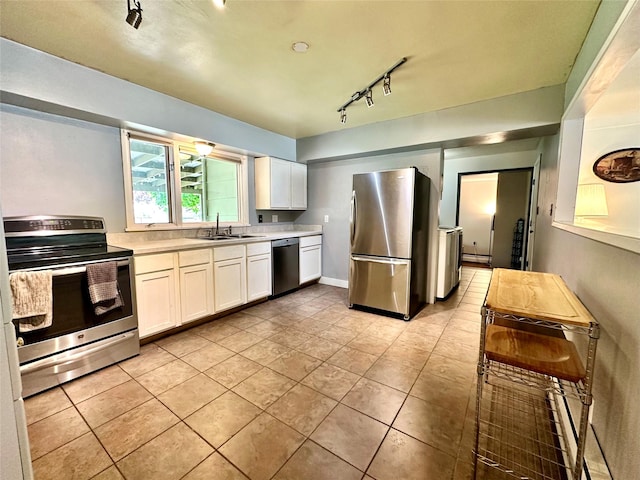 kitchen featuring appliances with stainless steel finishes, rail lighting, light countertops, and white cabinets