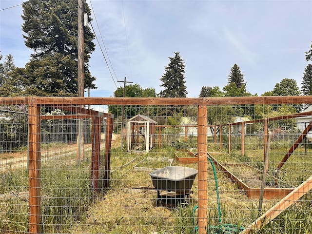 view of yard featuring a vegetable garden and fence