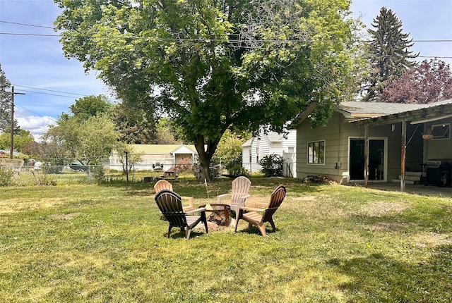 view of yard with a fire pit