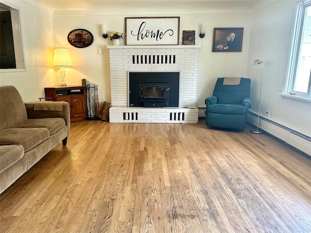 living area with wood finished floors, a fireplace, and baseboard heating
