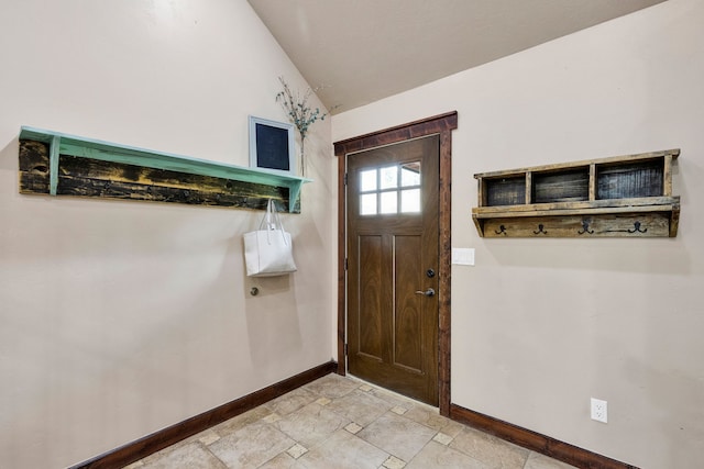440 E 20th St, Hamilton, MT 59840 - foyer featuring baseboards, light stone finish floors, and lofted ceiling