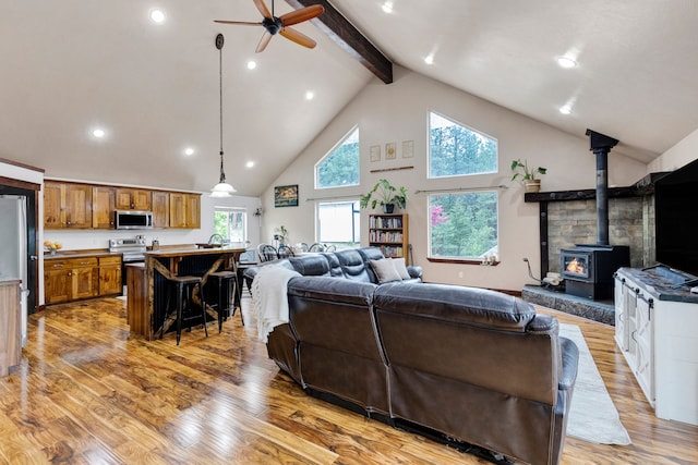 440 E 20th St, Hamilton, MT 59840 - living room featuring high vaulted ceiling, light wood finished floors, ceiling fan, beamed ceiling, and recessed lighting