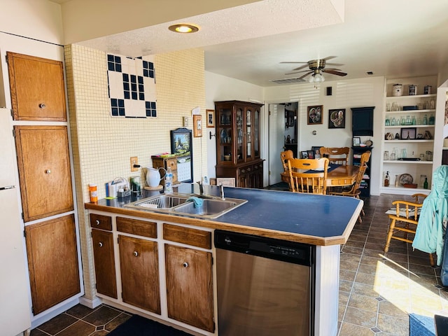 901 Birch Ave, Shelby, MT 59474 - kitchen featuring stainless steel dishwasher, a peninsula, a sink, freestanding refrigerator, and a ceiling fan