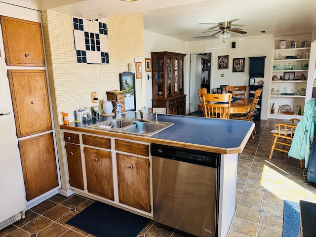 901 Birch Ave, Shelby, MT 59474 - kitchen with stainless steel dishwasher, a sink, a peninsula, freestanding refrigerator, and a ceiling fan