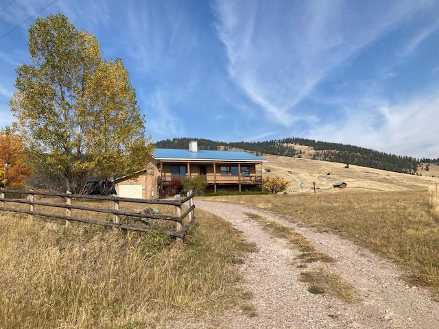42984 Flathead View Dr, Polson, MT 59860 - ranch-style home featuring fence, dirt driveway, a view of countryside, and a chimney