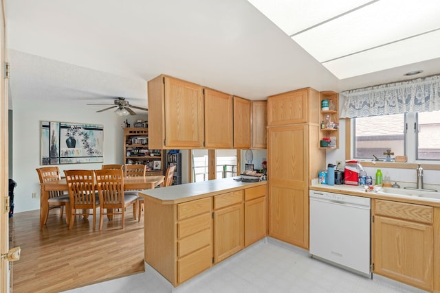 1200 32nd St S Unit 6, Great Falls, MT 59405 - kitchen with white dishwasher, a sink, a peninsula, a ceiling fan, and light brown cabinets