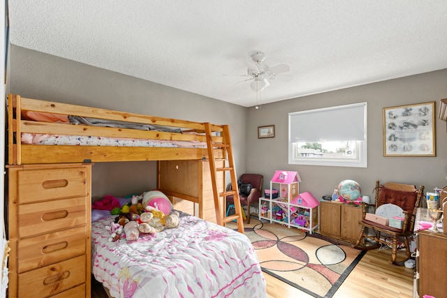1200 32nd St S Unit 6, Great Falls, MT 59405 - bedroom featuring wood finished floors, a textured ceiling, and a ceiling fan