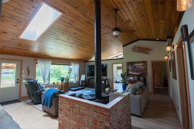 117 Woodland Estates Rd, Great Falls, MT 59404 - living area with a skylight, wood ceiling, a wood stove, light wood-style flooring, and vaulted ceiling