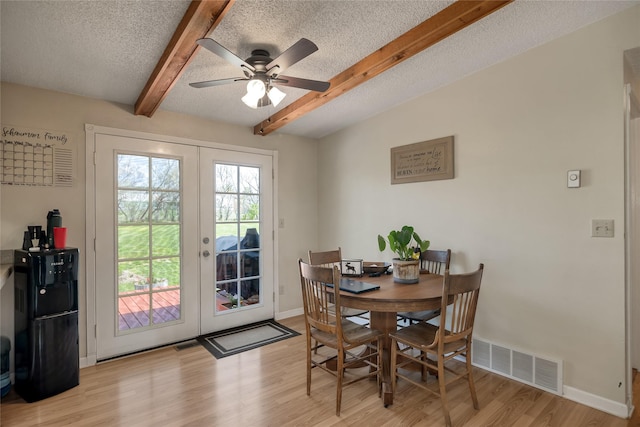 dining area with french doors, beam ceiling, light wood-style floors, baseboards, and a ceiling fan