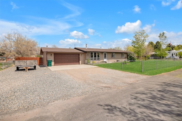 ranch-style house featuring gravel driveway and a garage