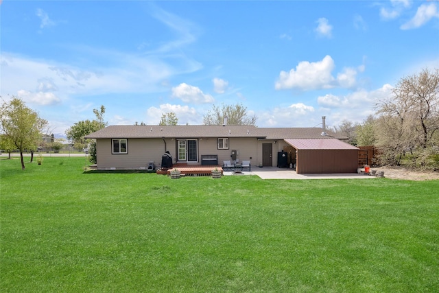 rear view of house with a yard and a wooden deck